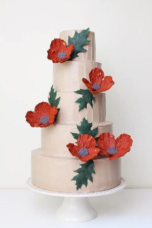 Vegan wedding cake Creme Brulee. Vanilla white cake, vanilla custard cream with vanilla seeds, caramel cream. ?❤️?❤️?
Decorations: white chocolate poppy flowers and leaves.
 at Physalis in Warsaw