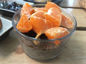 Chia pudding with banana topped with chocolate and tangerine at Joe's Place in Pico