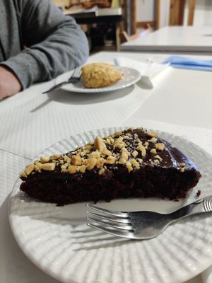 Chocolate and peanut cake, scone in the background at Veganeats Caffe in Lisbon
