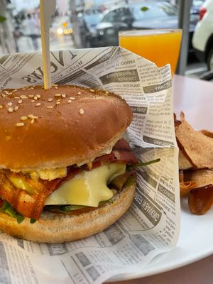 Beyond burger with an egg and orange juice. at Veganeats Caffe in Lisbon