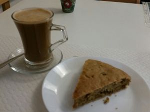 coffee with hazelnut milk and savory cake at Veganeats Caffe in Lisbon