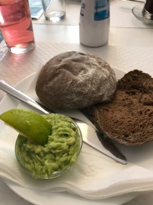 Bread with freshly chopped avocado & a slice of lime at Veganeats Caffe in Lisbon