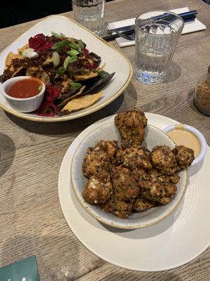 Nachos and cauliflower popcorn. Both DELICIOUS!   at Farmacy in West London