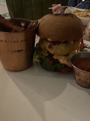 Beyond the burnt bun, it’s a pretty burger with melted cheese.  at Farmacy in West London