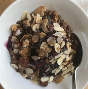 oatmeal w/ granola, pieces of chocolate, nuts etc  at Oatmeal in Paris