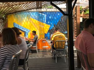 The patio is cute and comfortable. Beautiful artwork and even Van Gogh was here, ha ha. The painting has great affect. If it's hot order the frozen lemonade and many flavors to try.  at Crazy Burger in Narragansett