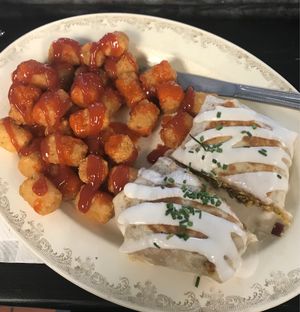 Breakfast burrito and tots with salt, pepper, ketchup and hot sauce   at The Tasty in Philadelphia