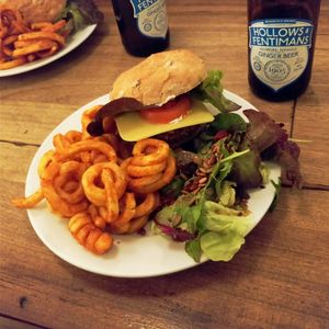 Vegan satay burger with curly fries and kino salad at Cafe Kino in Bristol
