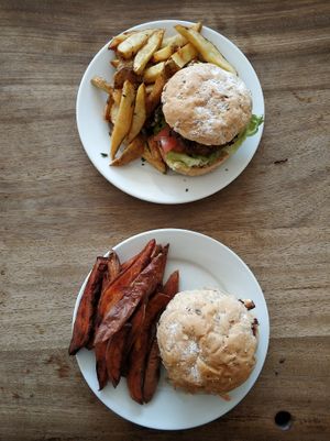Satay burger with seasoned sliced chips and BBQ burger with sweet potato chips at Cafe Kino in Bristol