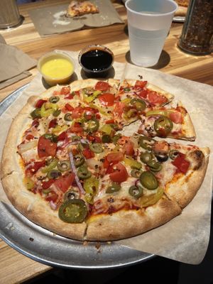 Jalapeño, banana pepper, red onion, green olive, and tomatoes. With balsamic glaze and garlic “butter” for dippingg  at Dells Pizza Lab in Wisconsin Dells