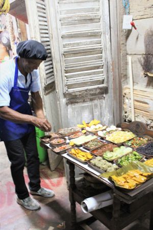Owner arranging the food at Baracoando in Baracoa