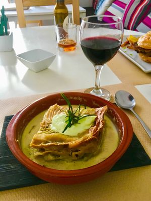 Lasagna and a glass of house wine.  at Nomit in Valencia
