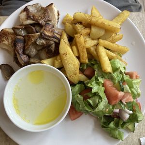 Fried mushrooms, celery fries, salad and garlic sauce   at Vyro Raw & Vegan Bistro in Bucharest