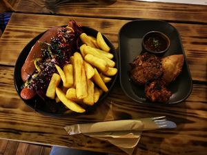 Korean slaw dog and Indian starter of samosa, pakora, and onion bhaji at Super Natural Newcastle in Newcastle Upon Tyne