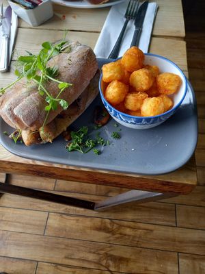 Vegan Sausage, Vegan Bacon & Fried Mushrooms sandwich with mini potato rosties. at Super Natural Newcastle in Newcastle Upon Tyne
