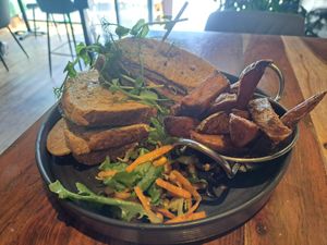 Vegan 'Chikn' sandwich with chips and salad. at Super Natural Newcastle in Newcastle Upon Tyne