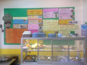 Prepared food and menu board at Phartom in Chiang Rai