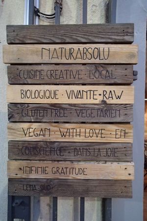Wooden sign-boards outside the restaurant at Naturabsolu in Villeneuve-les-avignon