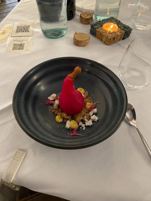 Poached pear in ginger syrup filled with chocolate mouse, served with walnut streusel at La Vimea - Vegan Hotel & Vegan Restaurant in Naturno