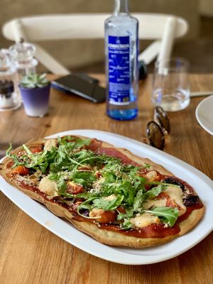Courgette base pizza with tomatoes and cashew cream cheese at Gioia Plant-Based Cuisine in Marbella