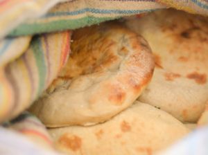 פיתות טאבון אפייה במקום at Hummus Badra - בדרה - חומוס פול מסבחה in Rehovot