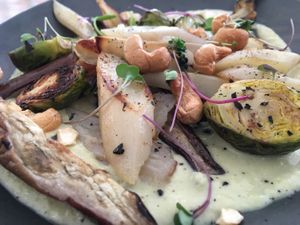 Oven roasted salfisis with eggplant and brussels sprouts in a white miso sauce at The Green Spot in Barcelona