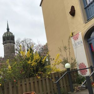 store front with famous church of LUTHER in background at VLORA Cafe & Laden im Hof in Lutherstadt Wittenberg