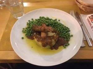 Buying sausage bangers on mash at Loving Hut in Rimini