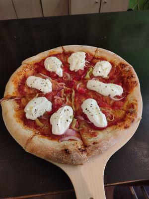 Pizza with vegan mozzarella on top at Trivoli Vegan Kafeneio in Athens