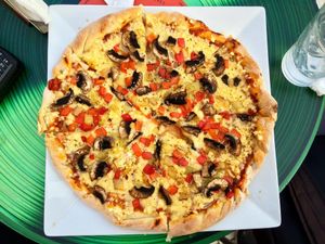 Pizza with roasted vegetables, mushrooms and vegan cheese. at Trivoli Vegan Kafeneio in Athens