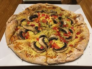 Tasty pizza with creamy cheese at Trivoli Vegan Kafeneio in Athens