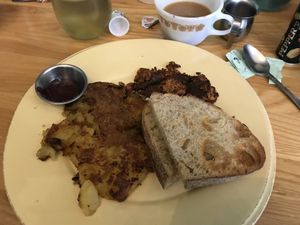 Toast, chorizo, potatoes, jam, and coffee with almond milk  at OliBea in Knoxville
