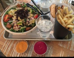 Kale Caesar, Guac Burger and fries  at By Chloe in Los Angeles
