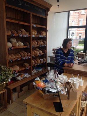 bread section and register at Happy Food Store in Schoten