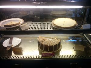 Dessert case. Raw pies, strawberry & coconut, chocolate mousse cake at Shangri-La Vegan - Telegraph in Oakland
