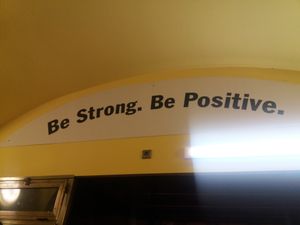 Inspirational quote over the exit at Loving Hut in Prague