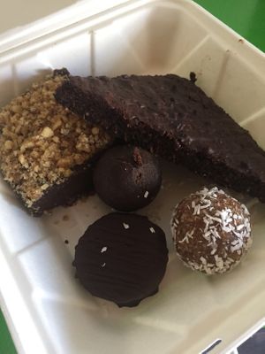 Clockwise from top left: Raw Fudge Bar, Dirty Brownie*, Vanilla Caramel Ball, Reese’s PB Cup, and Chocolate Matcha Ball. All vegan. at Green Table  in Santa Barbara