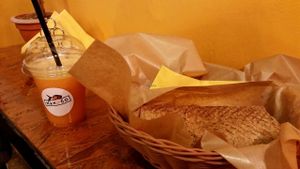 Orange juice and small flat bread with pineapple and avocado. at Mango Vegan Street Food - Zlota in Warsaw