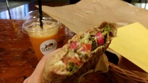 Orange juice and small flat bread with pineapple and avocado. at Mango Vegan Street Food - Zlota in Warsaw
