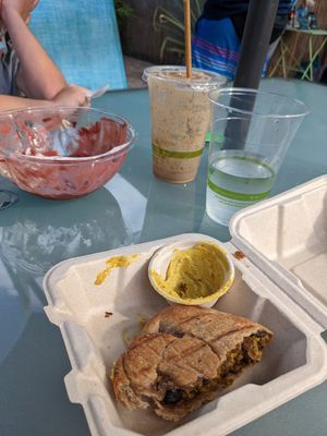 Remnants of pumpkin and quinoa empanada with cashew cheese, açaí bowl, and banana, peanut butter, cacao smoothie. at Degree 18 Juice Bar in Palmer