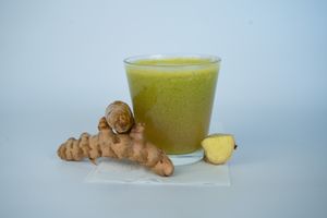 Throat and Flu tonic made from ginger, garlic, turmeric, lemon, wheatgrass, and orange at Glowing Plant Based Eatery in Los Angeles