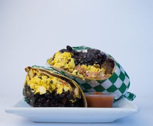 Black Bean Burrito made from tofu scramble, potatoes, vegan cheese, vegan bacon, rice, beans, vegan mayo, salsa, and wrapped in a tortilla at Glowing Plant Based Eatery in Los Angeles