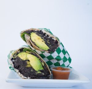 Black Beans & Rice Burrito made from black beans, rice, avocado,  vegan cheese, spinach, vegan mayo and salsa at Glowing Plant Based Eatery in Los Angeles