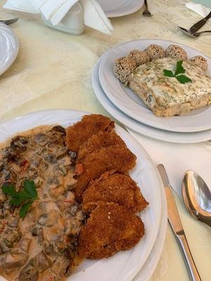 Left to right - mushroom stew , celery root snitzel . Creamy baked cauliflower and mushroom balls at Restaurantul Vegetarian Cris in Oradea