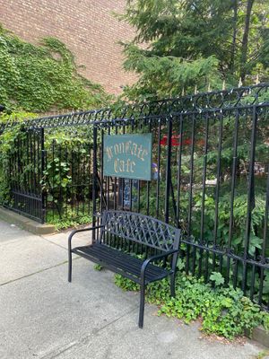 Exterior entrance, wrought iron gate and bench, sign reading IRON GATE CAFE at Iron Gate Cafe in Albany