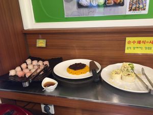 The sushi is on the left. Pumpkin dish and the veggie rolls to the right of it.  at Veg Green in Seoul