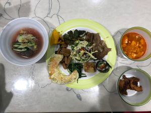 Cold noodle dish, mushrooms, pumpkin tempura, fried banana, kimbap, a wrap, salad, vegan meat, spicy tofu soup, vegan fried chicken with sauce. at Veg Green in Seoul