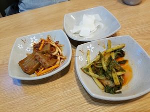 Side dishes. Acorn jelly and pickled radish are vegan, greens have a seafood in them at MeMilGongBang - Gangnam - 메밀공방 강남역점 in Seoul