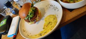 Celeriac and Fennel Burger with Fries on a brioche bun with green apple slaw, smoked tofu, piccalilli remoulade and rocket at Meatless District - Da Costabuurt in Amsterdam