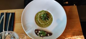 Salsify Velouté with crispy shallot, truffle, ‘Parmesan’ and mustard greens at Meatless District - Da Costabuurt in Amsterdam